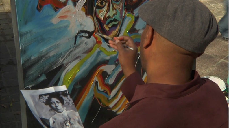Corey Barksdale painting a portrait on canvas from a photo reference during a live painting event