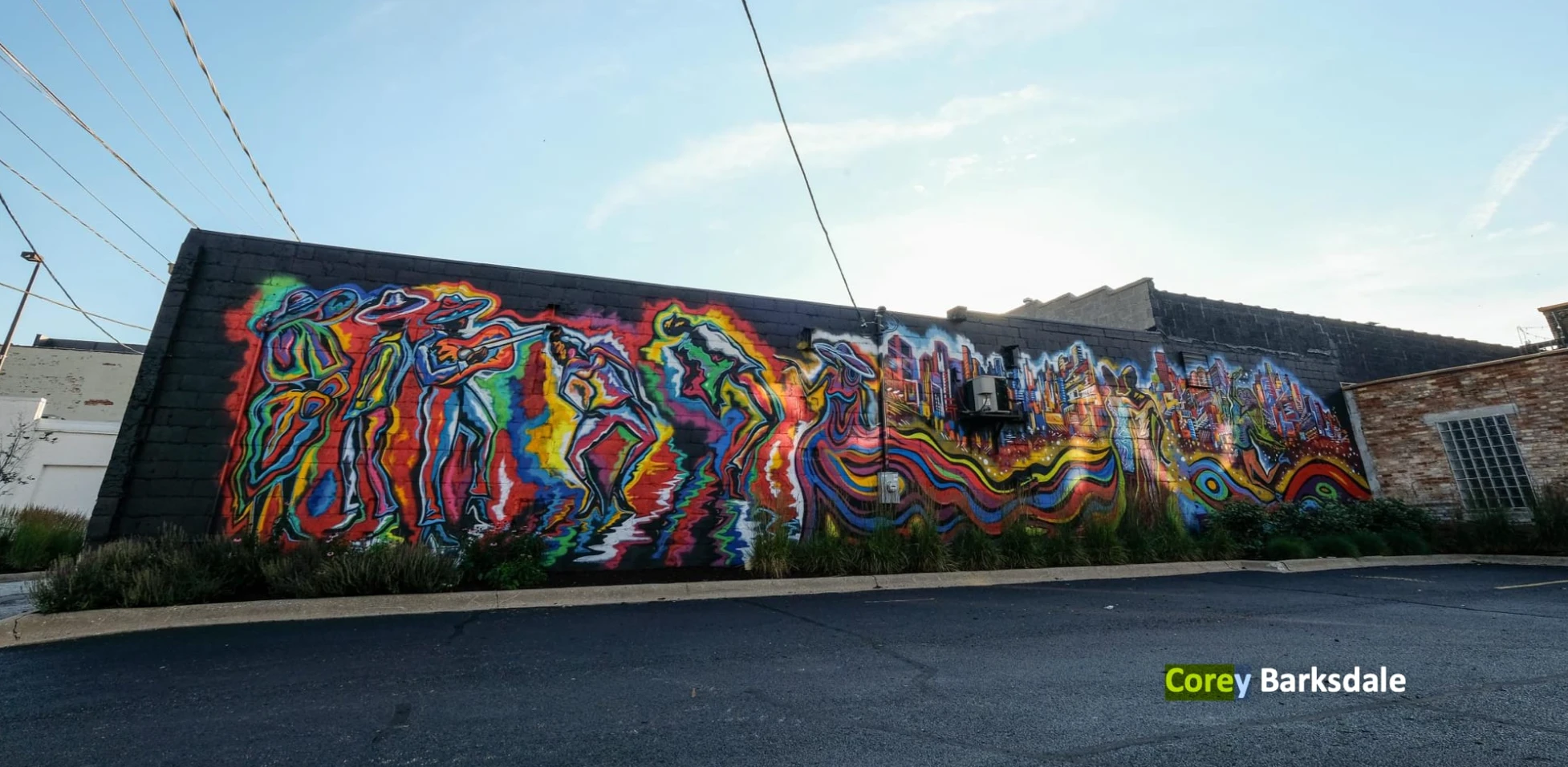 Corey Barksdale's CRE8IV mural on East State Street in Rockford, Illinois, photographed at dusk across the parking lot