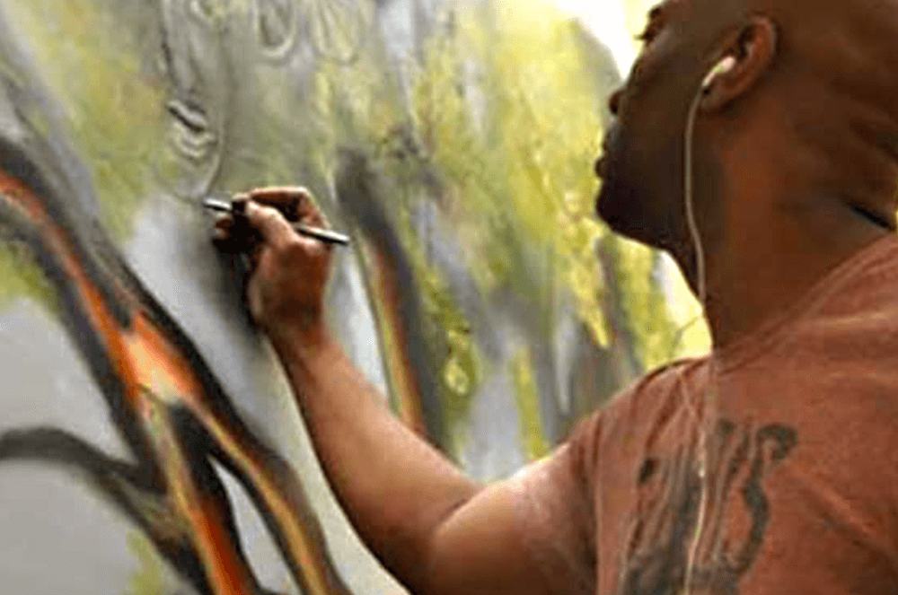 Close-up detail of Corey Barksdale live painting an original artwork